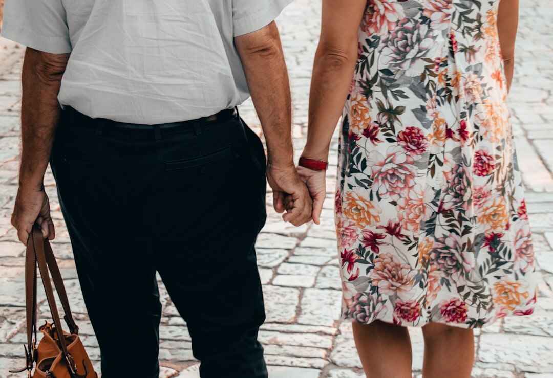 elderly couple holding hands