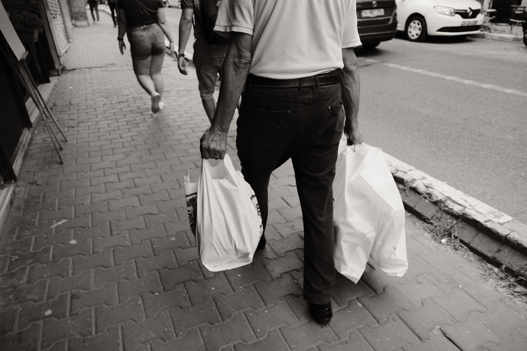 old man carrying groceries