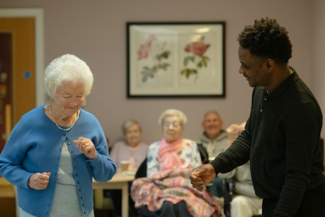 Senior woman receiving a membership card from a staff member