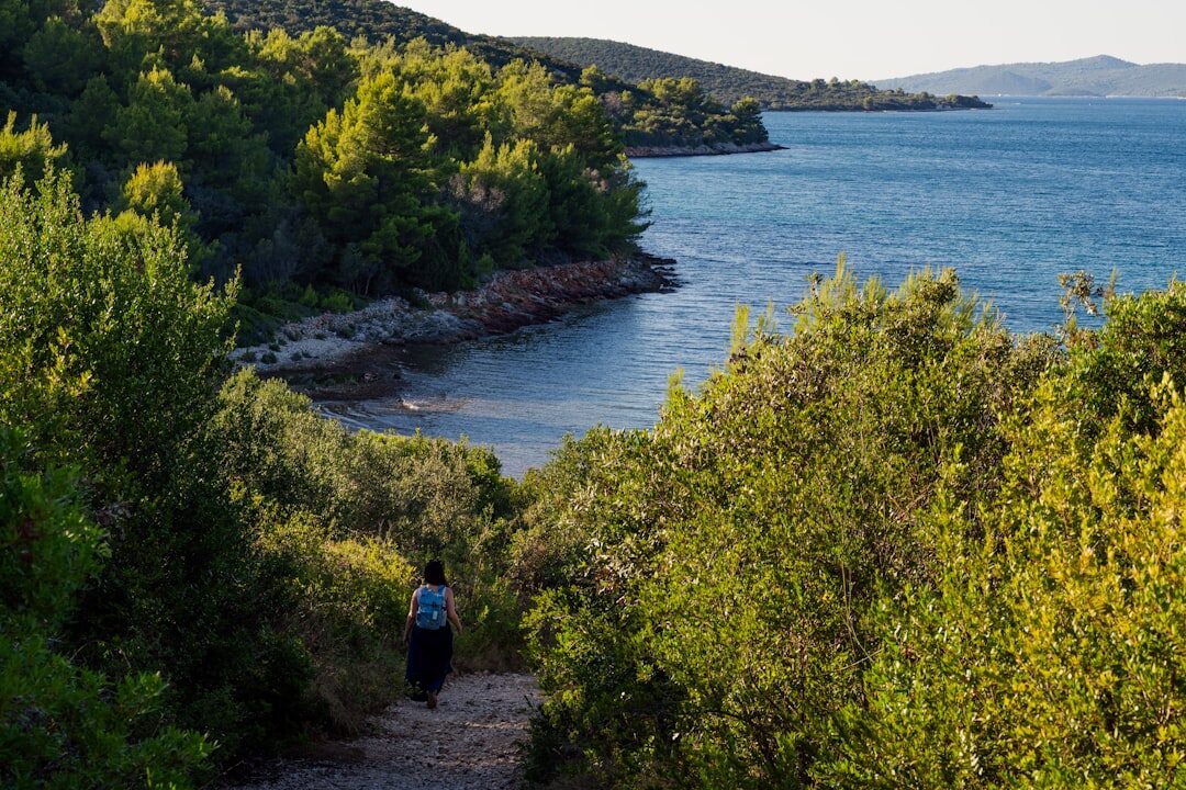 Group of senior friends walking together on a nature trail in Croatia