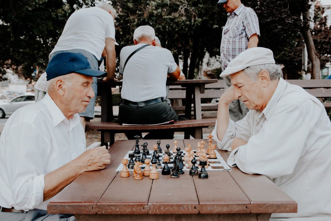 group seniors playing chess
