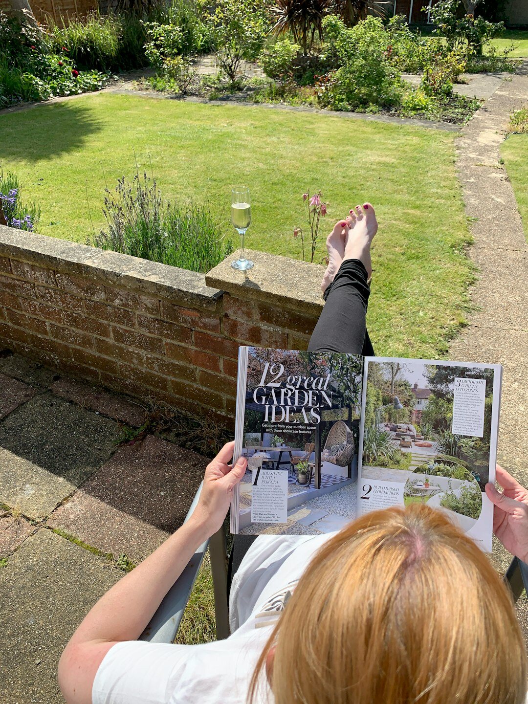 senior reading book in garden