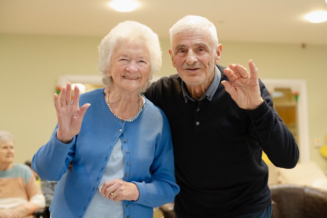 Senior citizens doing a gentle group exercise class indoors
